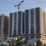 Tall Modern Residential Tower With Balconies At Metro Central Plaza Clifton Block 9, Street View With Trees And Vehicles