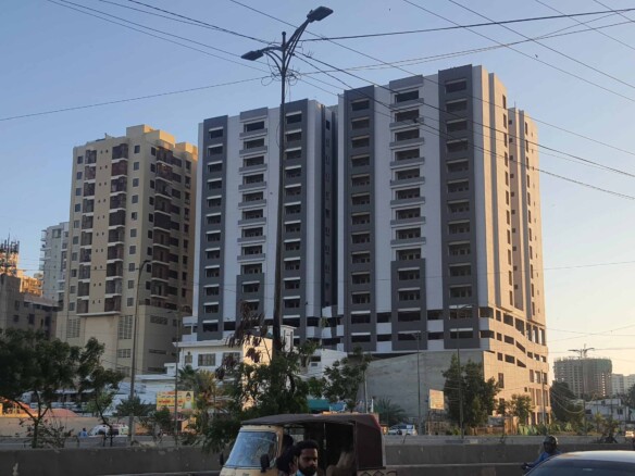 Tall Modern Residential Tower With Balconies At Metro Central Plaza Clifton Block 9, Street View With Trees And Vehicles