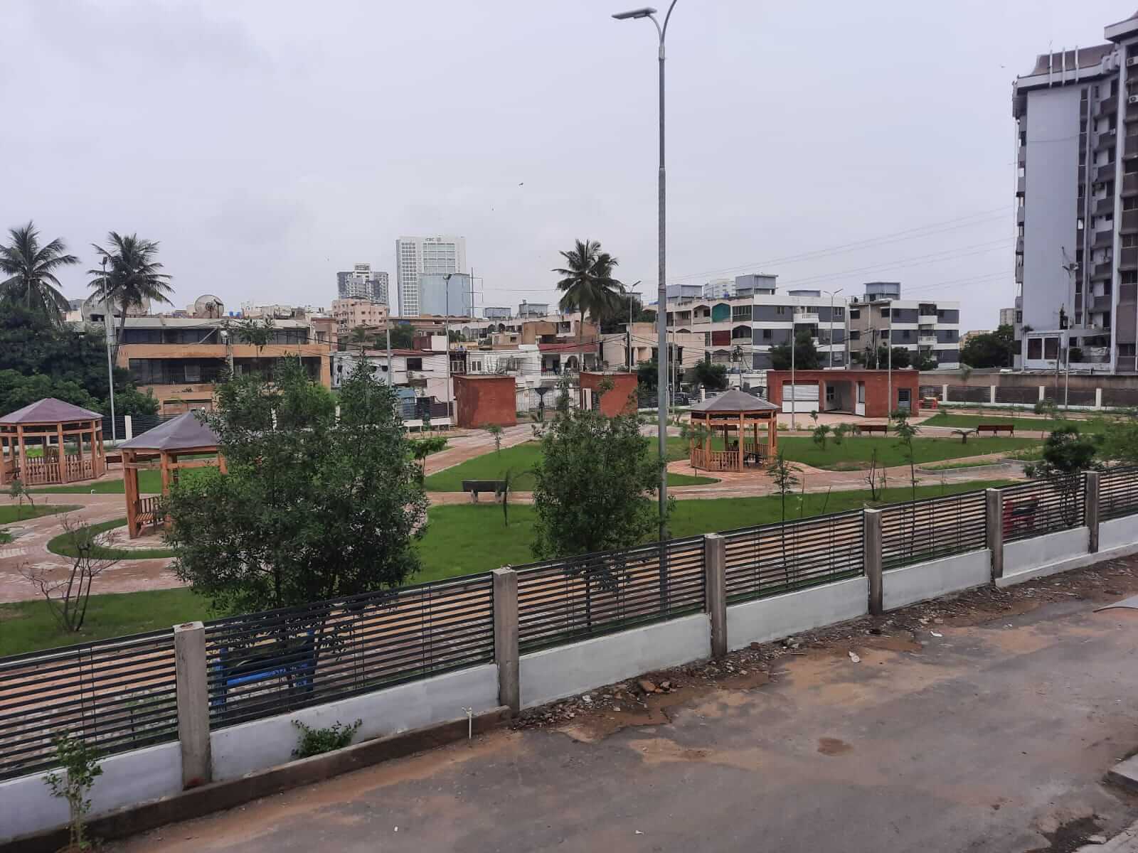Dunes Marvel 3-Bedroom Apartment for Sale in Clifton Block 5 Karachi (10) Clifton Block 5 Karachi park with wooden gazebos, lawns and city buildings near Dunes Marvel 3-bedroom apartment