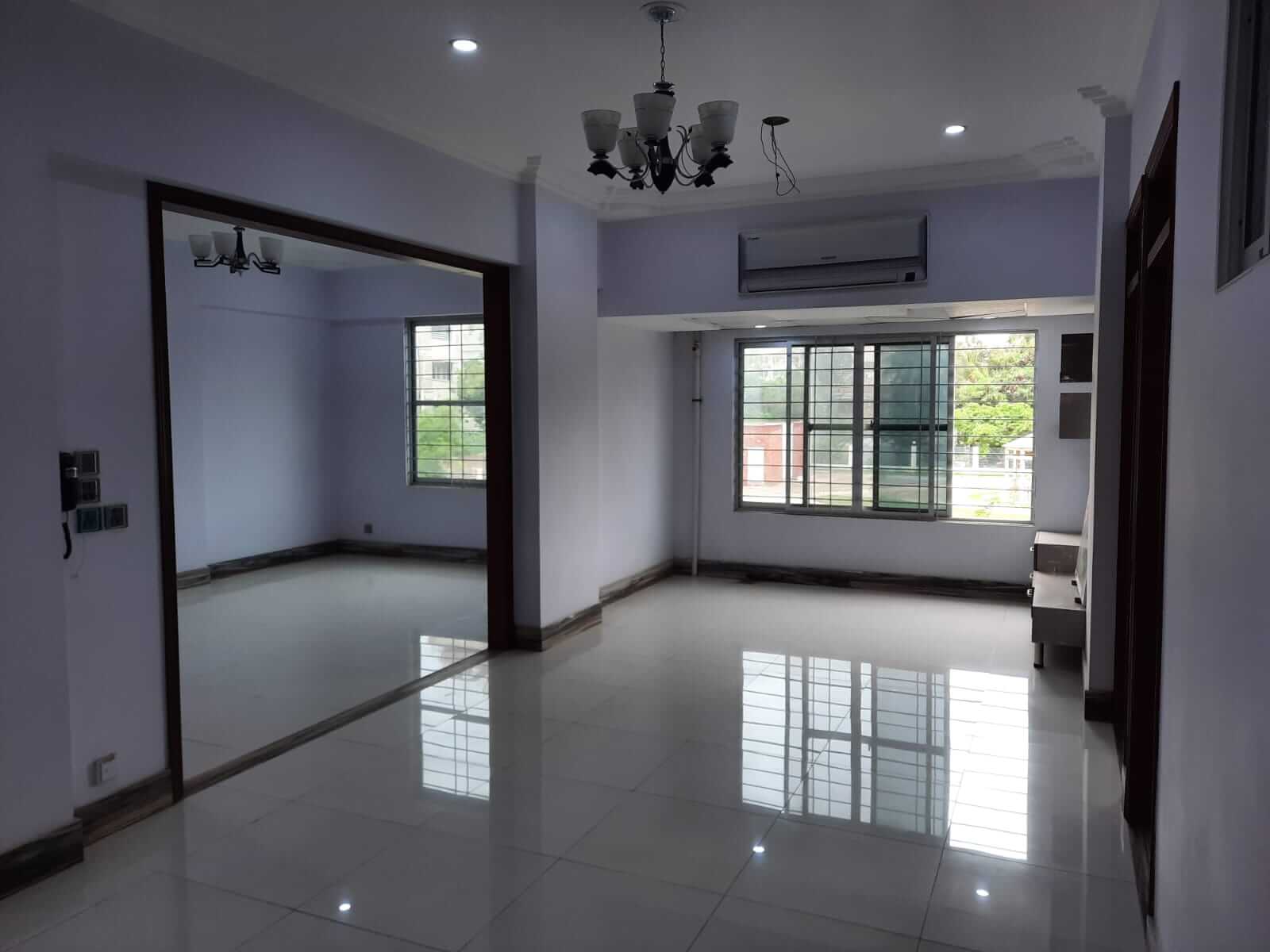 Dunes Marvel 3-Bedroom Apartment for Sale in Clifton Block 5 Karachi (15) Empty living area of 3-bedroom apartment at Dunes Marvel in Clifton Block 5 Karachi featuring chandelier, air conditioner and