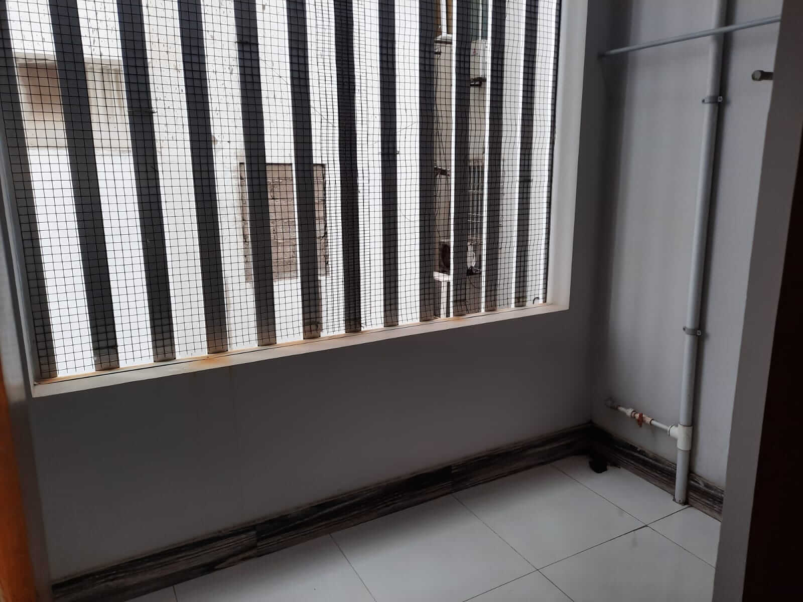 Dunes Marvel 3-Bedroom Apartment for Sale in Clifton Block 5 Karachi (17) Room with security barred window and white tiles in Dunes Marvel 3-bedroom apartment Clifton Block 5 Karachi