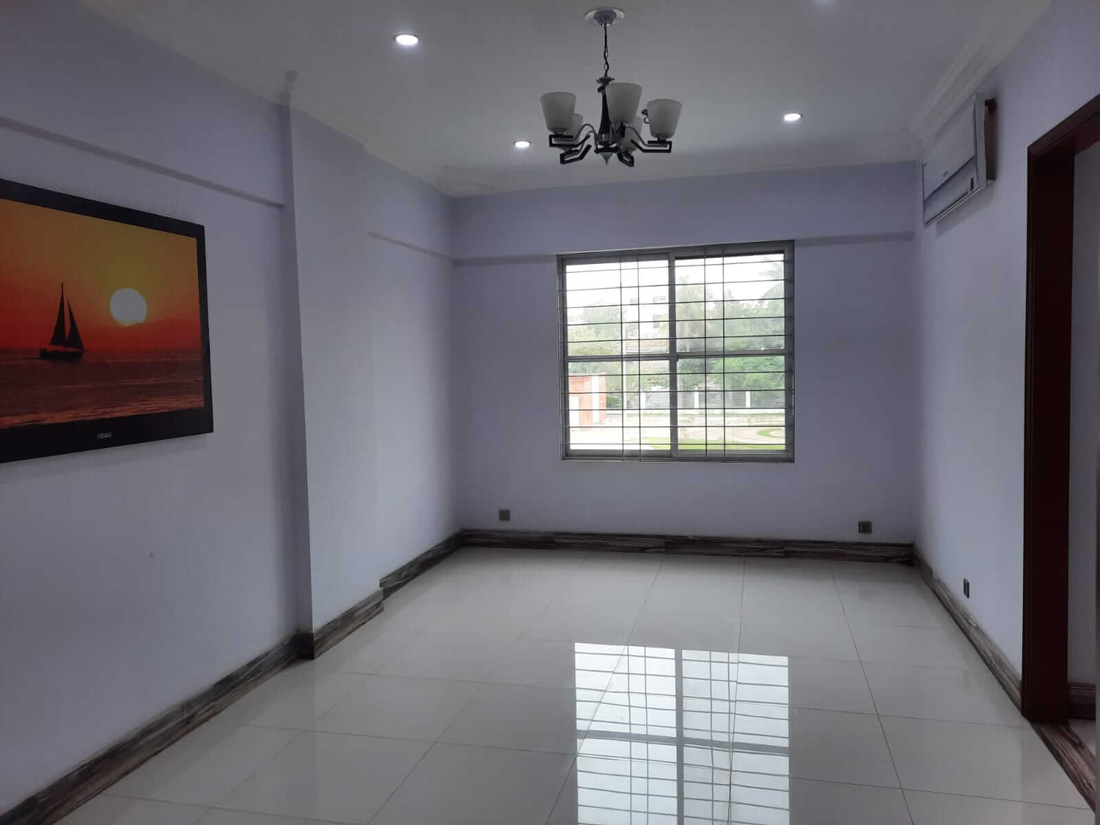 Dunes Marvel 3-Bedroom Apartment for Sale in Clifton Block 5 Karachi (18) Empty room in Dunes Marvel 3-bedroom apartment Clifton Block 5 Karachi with chandelier, window and air conditioner