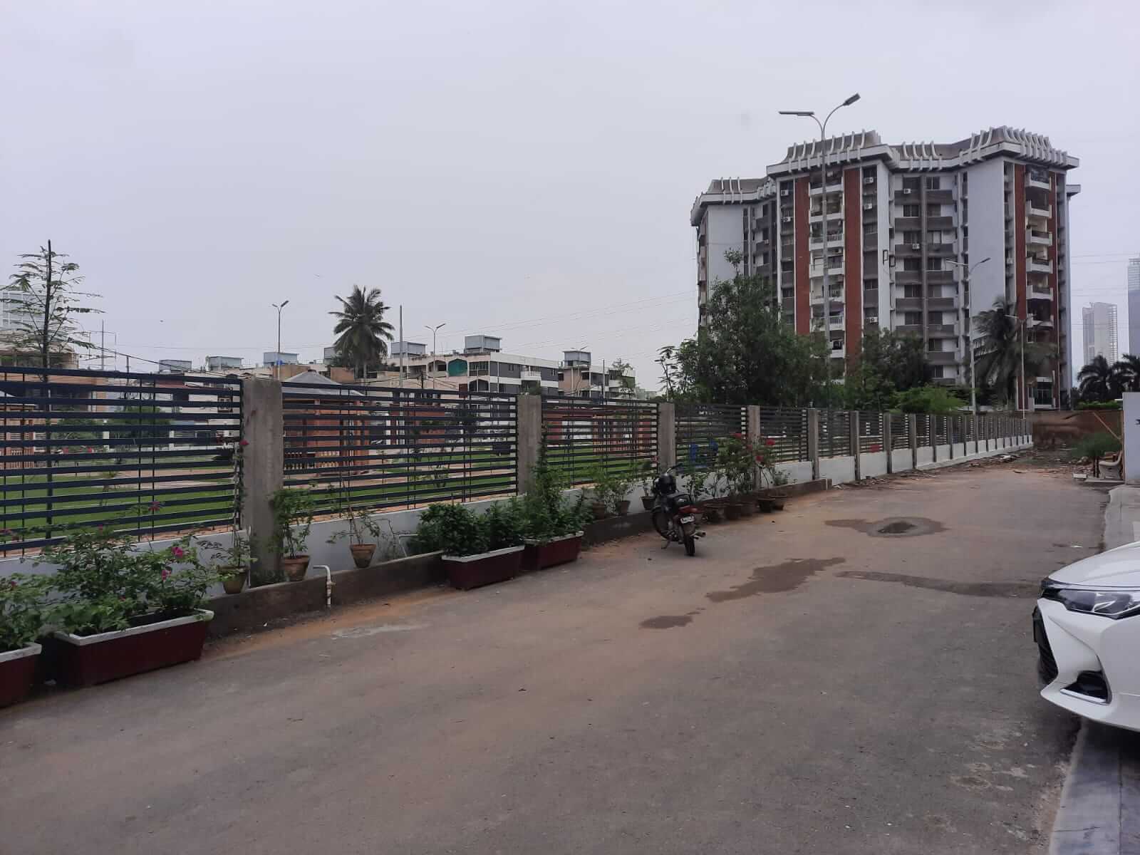 Dunes Marvel 3-Bedroom Apartment for Sale in Clifton Block 5 Karachi (20) Dunes Marvel apartment building exterior in Clifton Block 5 Karachi showing multi-story facade, fence and street view