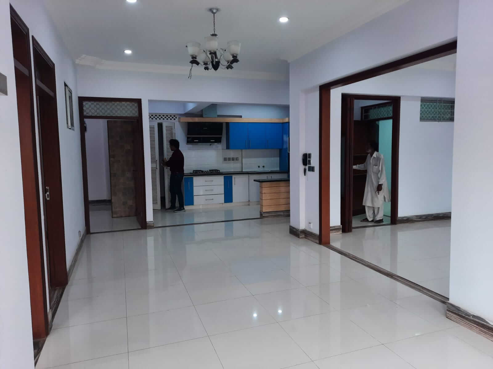 Dunes Marvel 3-Bedroom Apartment for Sale in Clifton Block 5 Karachi (3) Spacious living area in 3-bedroom apartment at Dunes Marvel Clifton Block 5 Karachi with modern kitchen and glossy white floo