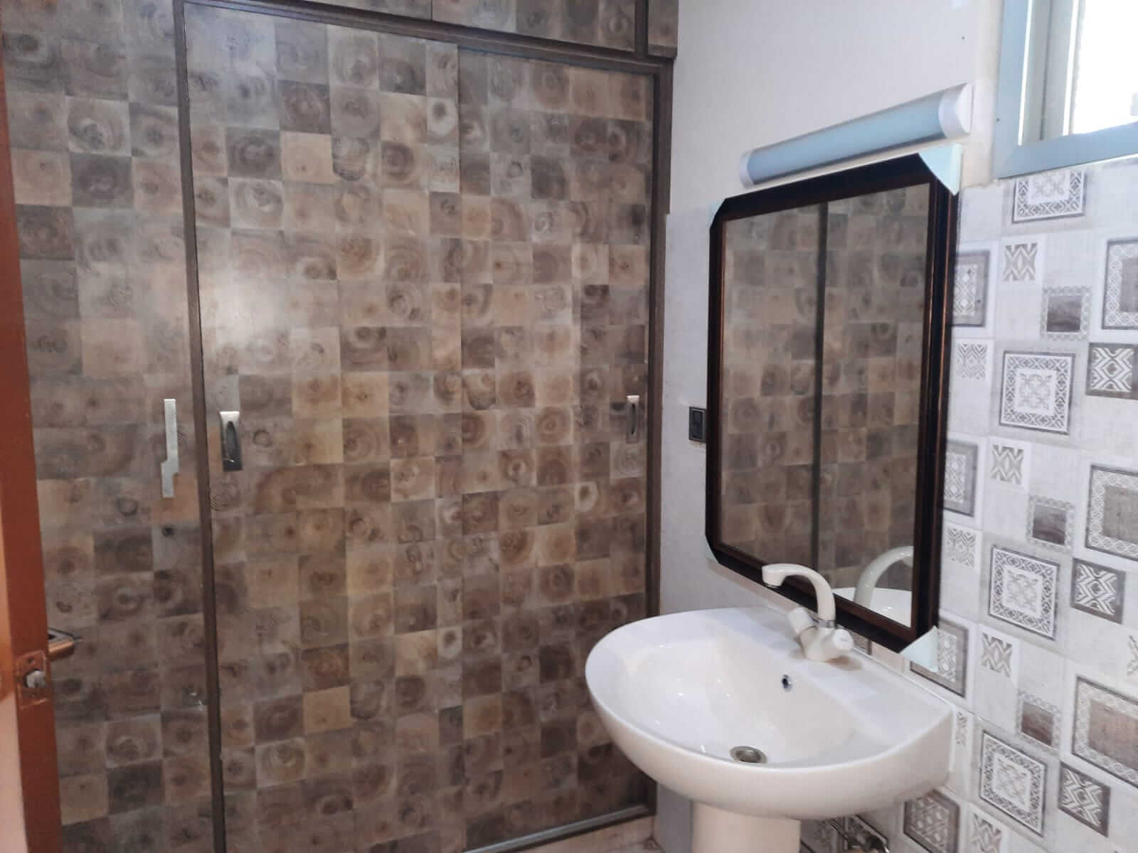Dunes Marvel 3-Bedroom Apartment for Sale in Clifton Block 5 Karachi (8) Bathroom with white sink, mirror and tiled shower in Dunes Marvel Clifton Block 5 Karachi