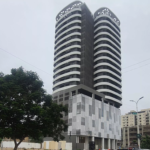 Modern Twin-Tower Apartment Building In Country 8 Clifton With Curved White Facades, Balconies, And Dark Accents