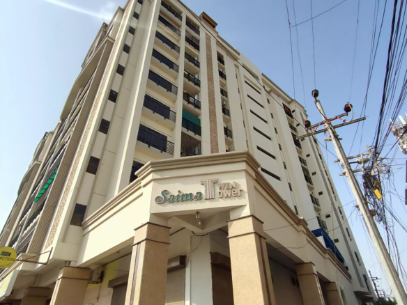 Saima Twin Towers Exterior In Kda Scheme 1, Multi-Story Beige Building With Balconies, Pillars At Entrance, And Signage