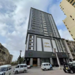 Modern High-Rise At Clifton Marina Block 7 With Grey Facade, Balconies, Clifton Marina Signage, Street View, Parked Vans And