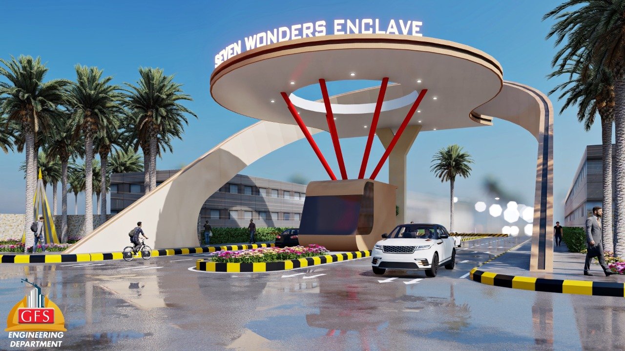 Seven Wonders Enclave Prime 120 yd Plot for Sale in Karachi Grand entrance gate of Seven Wonders Enclave in Karachi with curved white canopy, red supports, palm trees, flower beds, and