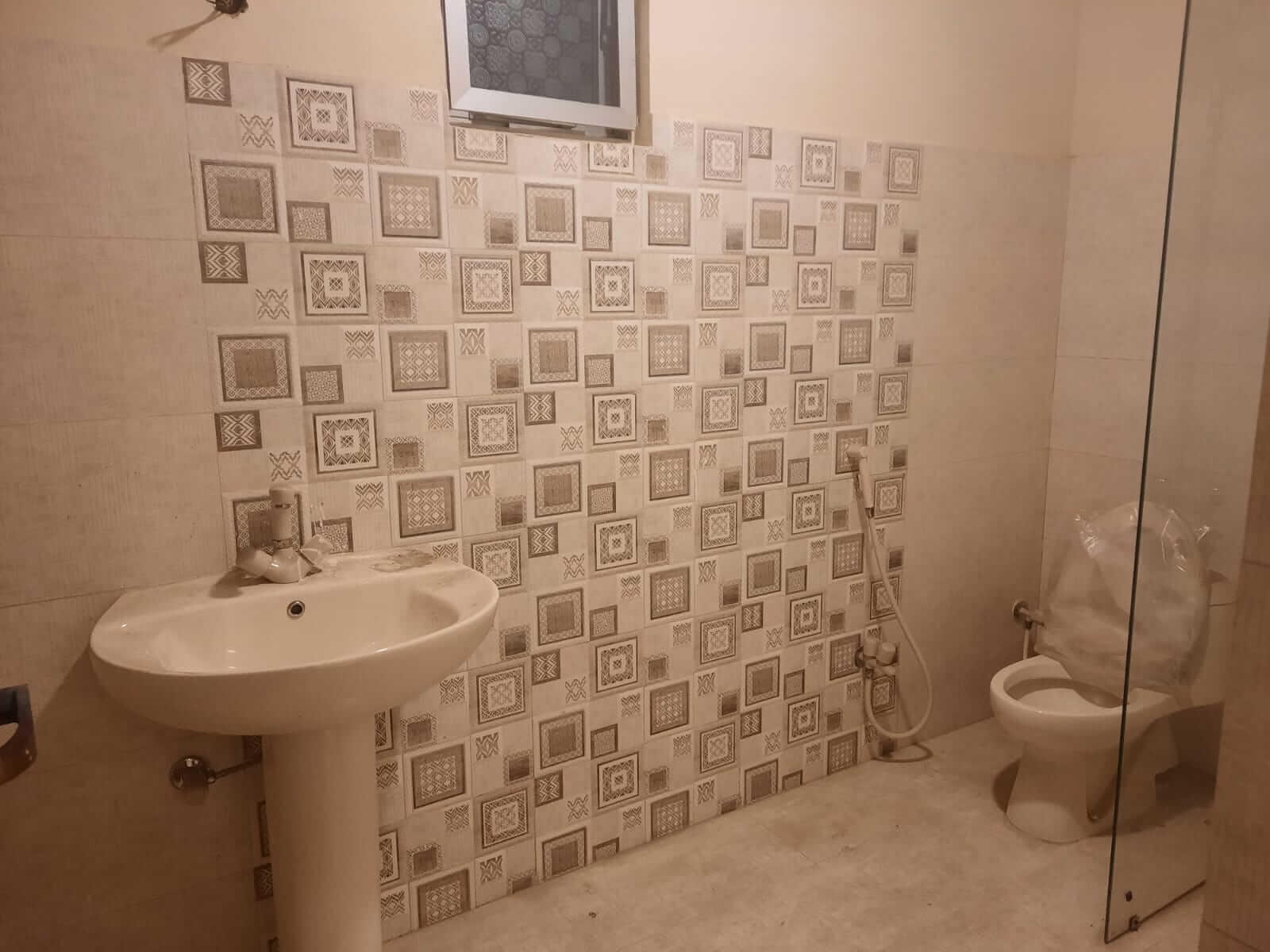 Dunes Marvel Clifton 3-Bedroom Flat for Sale in Clifton Block 5 Karachi (4) Pedestal sink and patterned tile bathroom in Dunes Marvel Clifton apartment Clifton Block 5