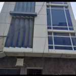 Modern 1100 Sqft Office Exterior In Dha Phase 7 With Large Blue-Tinted Windows, Vertical Sunshades, And Ground Floor Entrance