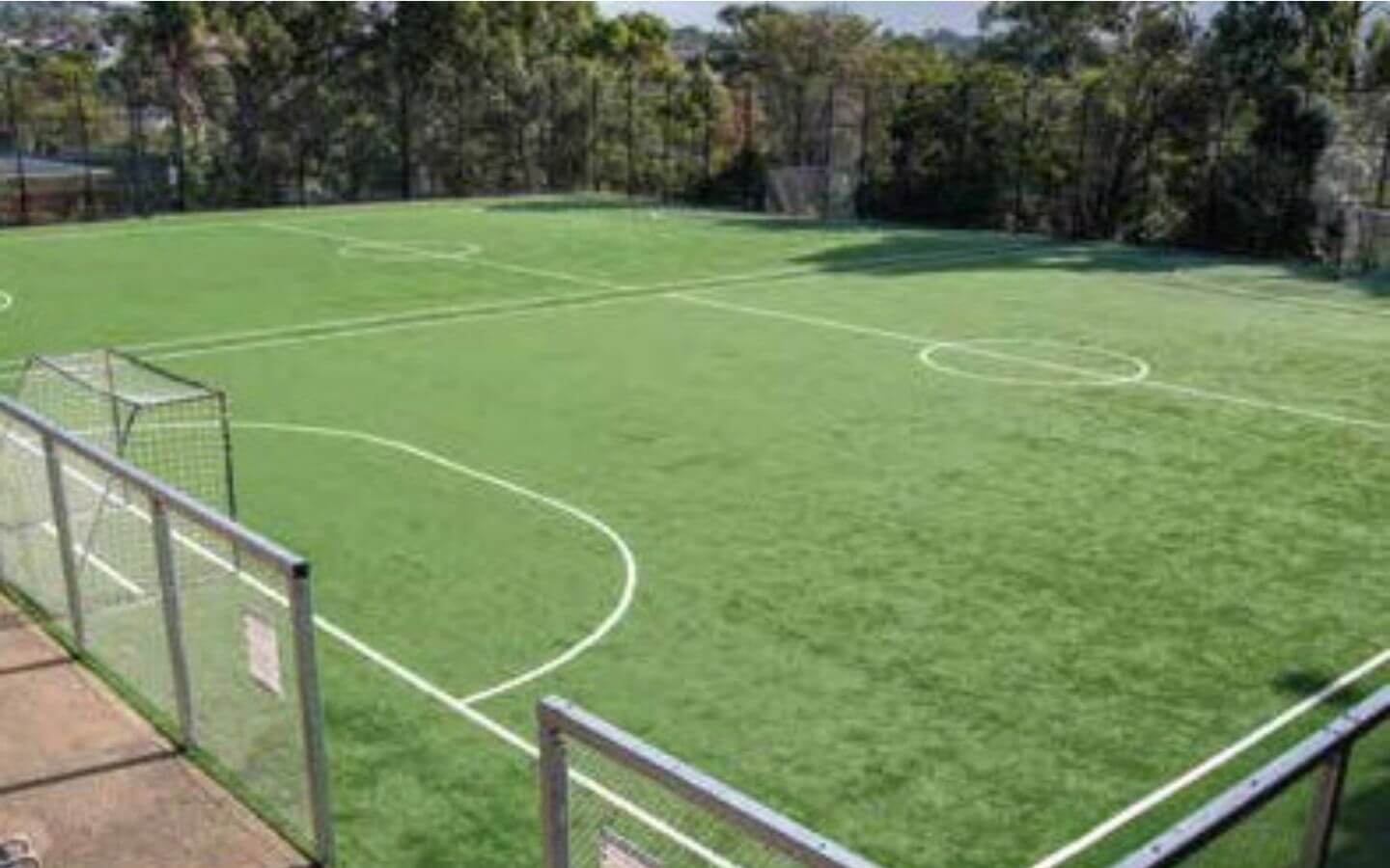 Askari Villas Karachi 270 Sq Yd Luxury by MaxX Capitals (4) Artificial turf football pitch with goalposts, markings, fencing and trees at Askari Villas, Askari VI, Karachi