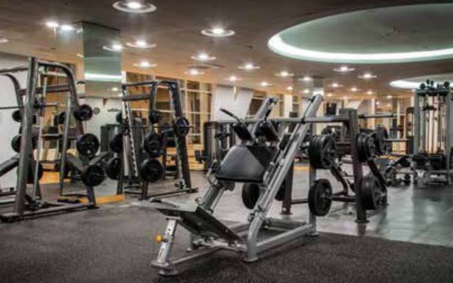 Askari Villas Karachi 270 Sq Yd Luxury by MaxX Capitals (5) Spacious modern gym with leg press machines, weight racks, mirrors and rubber flooring in Askari Villas Karachi