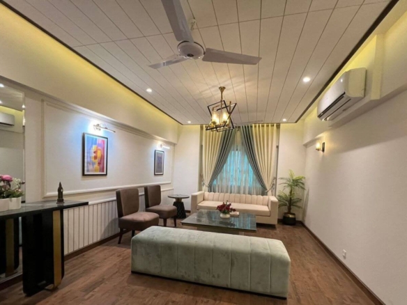 Spacious Living Room In 4 Bed Apartment For Sale Clifton Block 8 Greens 3 With Cream Sofa, Modern Chandelier, Wooden Floors,