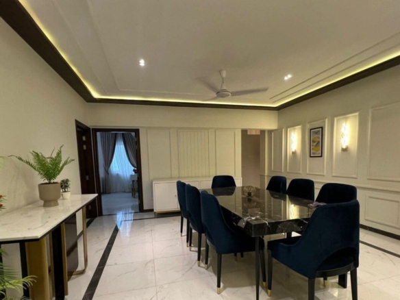 Dining Room In 4 Bed Apartment Greens 3 Clifton With Black Marble Table, Blue Velvet Chairs, White Marble Console, Plants, Pa
