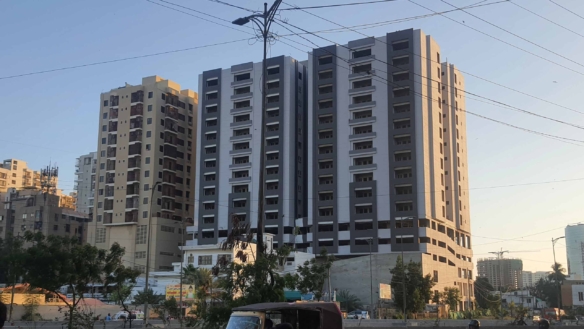High-Rise Towers Of Metro Central Plaza With Modern Grey Facades, Balconies, Streetlights And Urban Surroundings