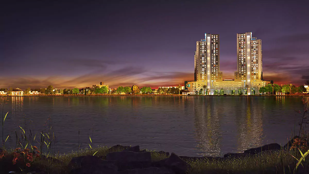 Luxury Living 4 Bedrooms Flat for Rent In COM3 Tower Clifton Block 6 Karachi (5) Night view of COM3 Tower Clifton with two illuminated high-rise buildings reflected in waterfront