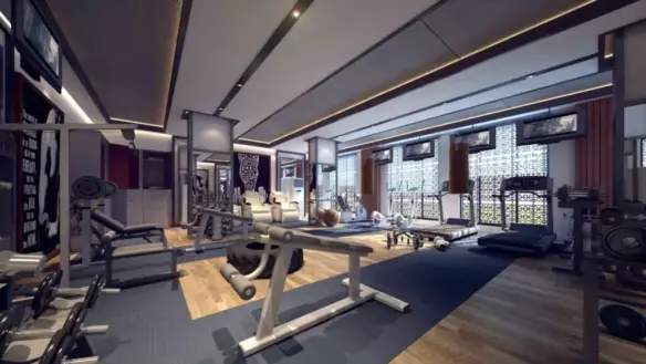 Spacious modern gym in Burj Al Jinnah with treadmills, weight benches, racks, dumbbells, and large windows