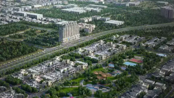 Aerial view of Burj Al Jinnah tower amid villas, landscaped gardens, pools, tennis court, and green spaces