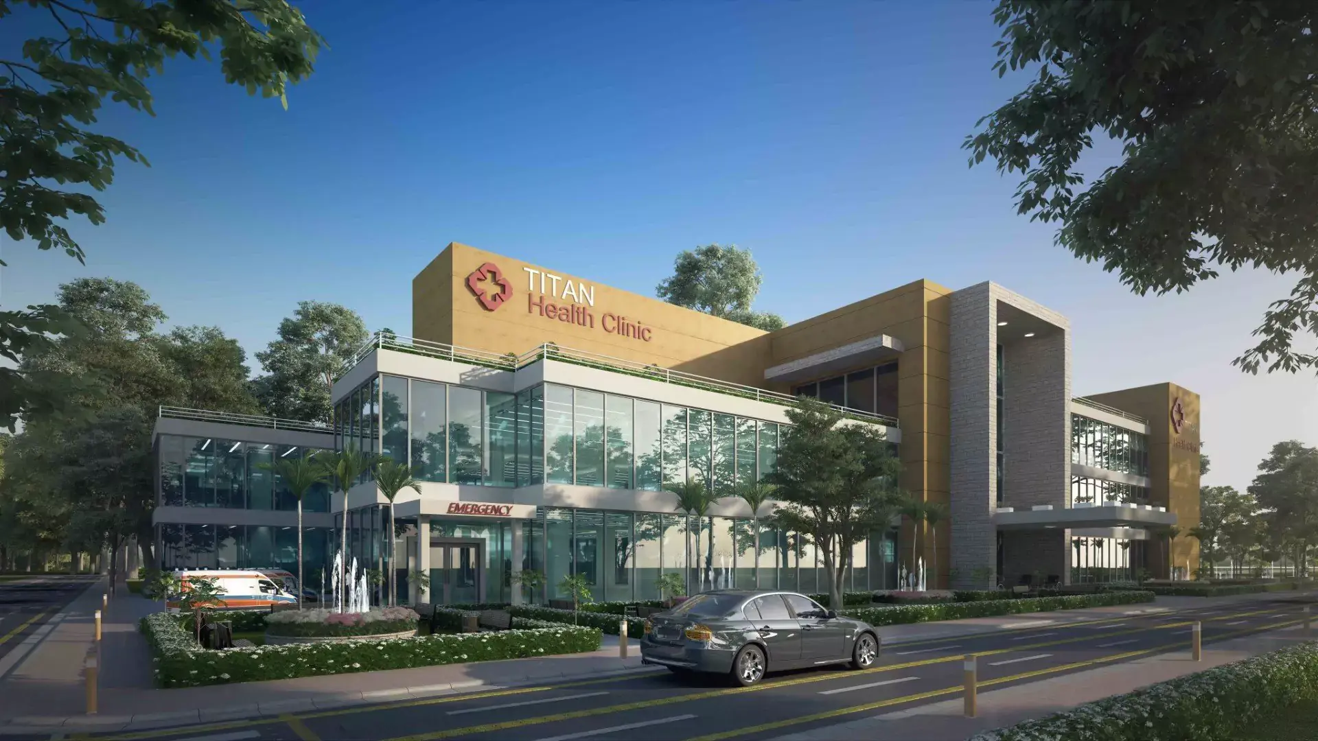 Titan Enclave: 120 Yd Residential Plot New Booking in Karachi – N-5 Highway Modern Titan Health Clinic in Titan Enclave, Karachi, with beige and glass facade, trees, fountain, cars, and road access
