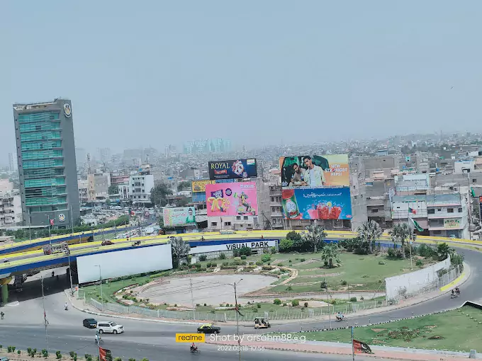 Smart Tower 2 Prime Location Offices for Sale in Karachi (3) Smart Tower 2 high-rise office tower in Karachi with glass facade overlooking roundabout, flyover, billboards and urban skyli