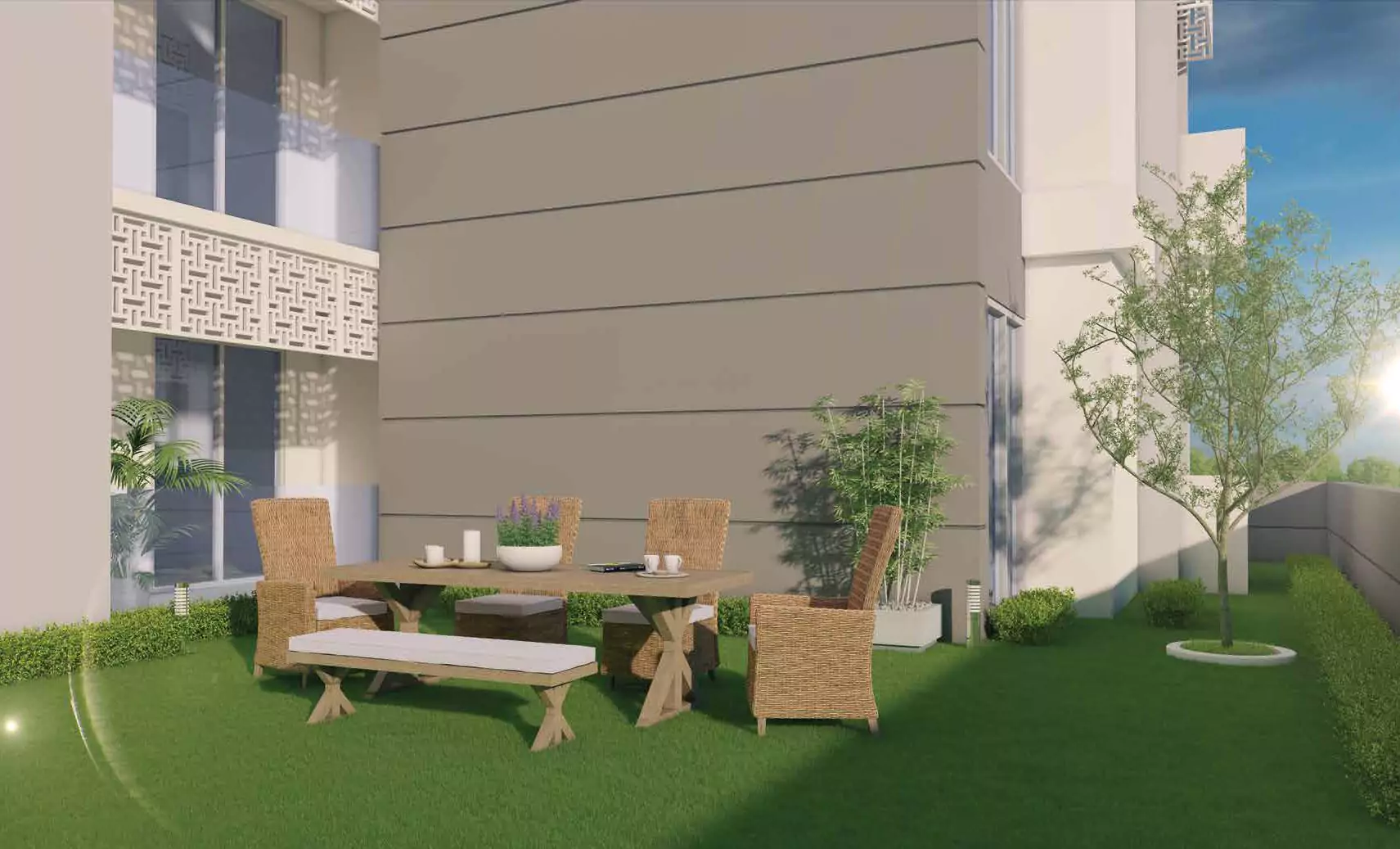 The Court Heights Outdoor Sitting Luxury Flats for Sale In Karachi Terrace at The Court Heights luxury flats in Karachi with wicker table, chairs, bench on green lawn, plants, and modern gray
