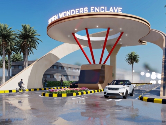 Grand Entrance Gate Of Seven Wonders Enclave In Karachi With Curved White Canopy, Red Supports, Palm Trees, Flower Beds, And 
