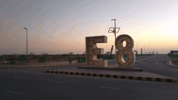 Prominent E8 Sign At Dha Phase 8 Roundabout With Wide Roads And Streetlights For 1000 Square Yard Plots
