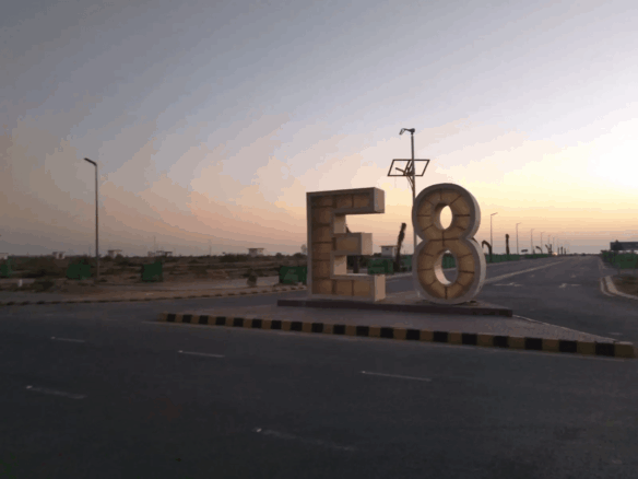 Prominent E8 Sign At Dha Phase 8 Roundabout With Wide Roads And Streetlights For 1000 Square Yard Plots