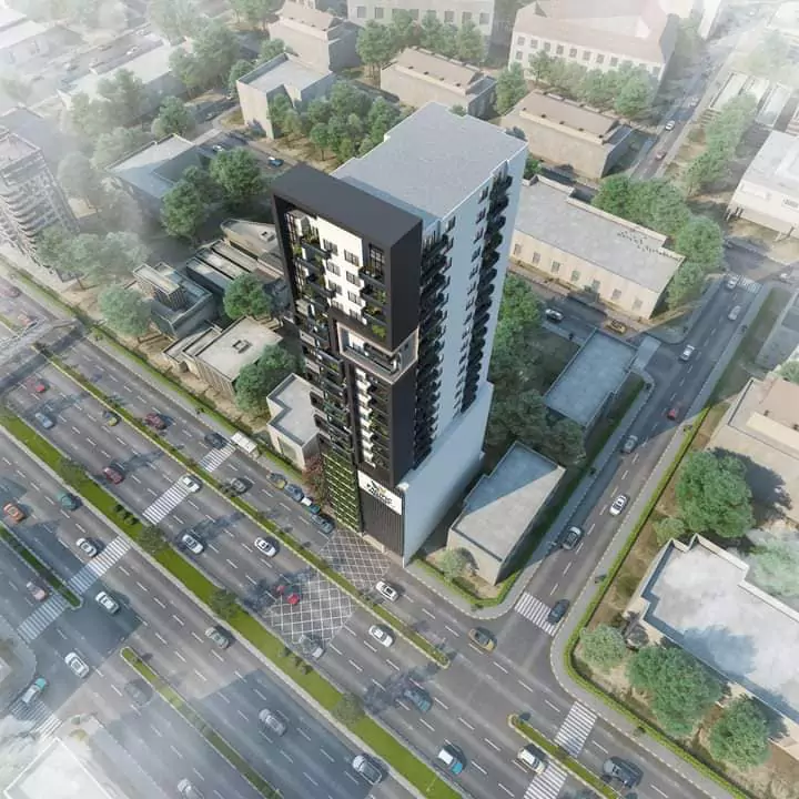 Pacific Residency Clifton Luxury 3-Bedroom Apartments For Sale In Block 7 Clifton Karachi Exclusive Community (7) Aerial view of Pacific Residency Clifton high-rise tower with sleek black and white facade, green balconies, urban streets an