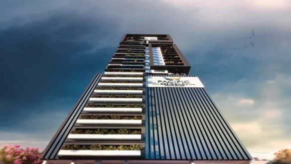 Towering Modern Facade Of Pacific Residency Clifton High-Rise With Glass Panels, Vegetated Balconies, And Prominent Signage