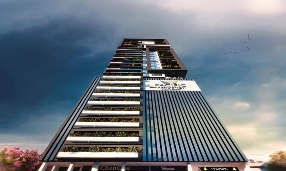 Towering modern facade of Pacific Residency Clifton high-rise with glass panels, vegetated balconies, and prominent signage