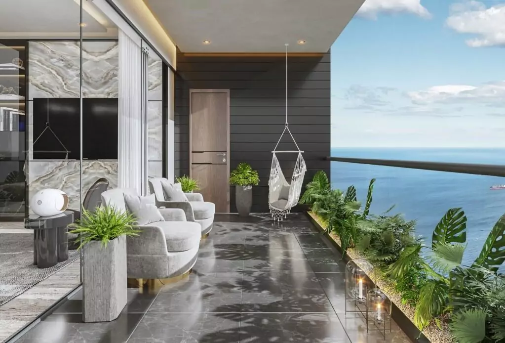 AA Waterfront Apartments Luxury Flats & Penthouse For Sale In DHA Phase 8 Karachi (10) Spacious AA Waterfront Apartments balcony with ocean view, white armchairs, hanging swing chair, potted plants, glass doors,