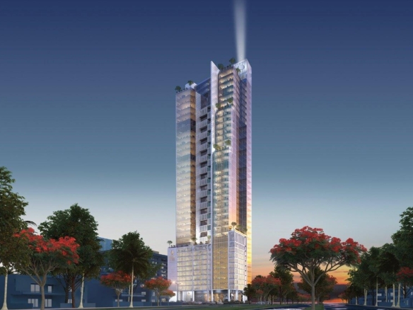 Modern High-Rise Tower With Illuminated Spire At Dusk, Glass Facades, Surrounded By Palm Trees And Red-Flowering Trees