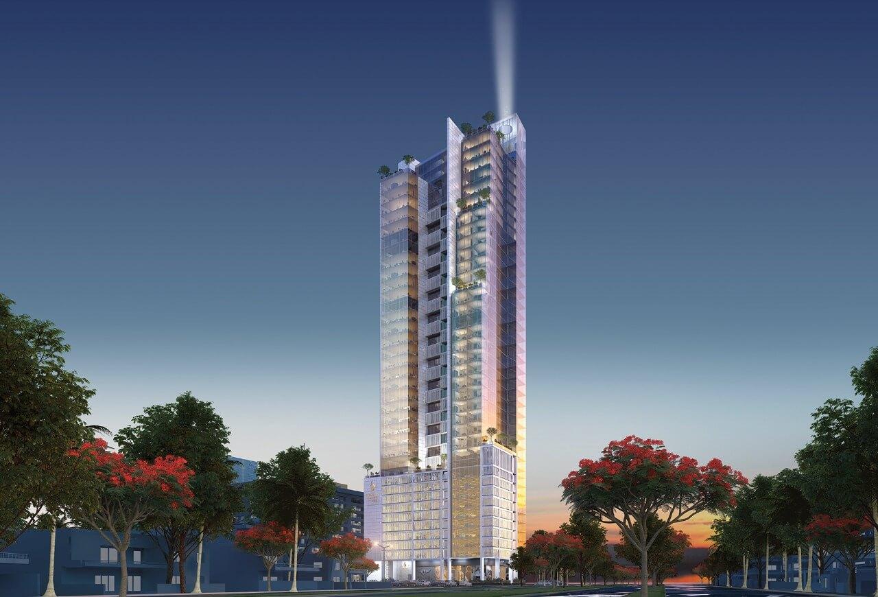Modern high-rise tower with illuminated spire at dusk, glass facades, surrounded by palm trees and red-flowering trees