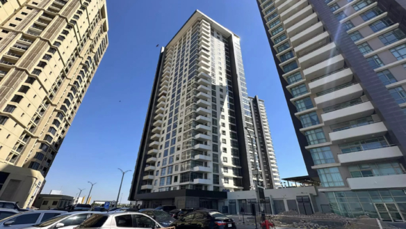 Modern High-Rise Apartment Towers In Emaar Pearl With Glass Facades, Balconies And Sunny Exterior View