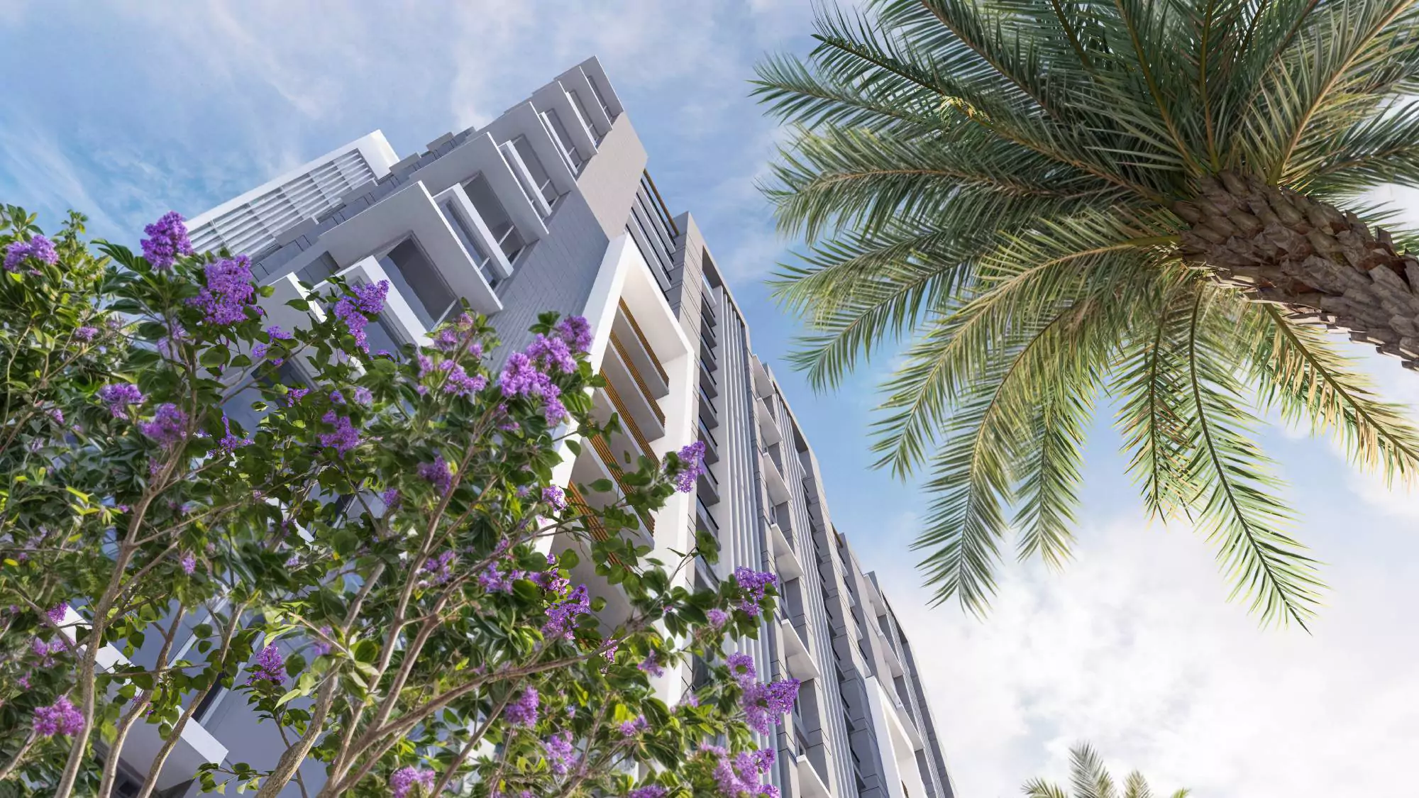 Saima Shield Towers Luxury Flats For Sale in Gulshan-e-Iqbal Near Mosamiyat (6) Saima Shield Towers high-rise in Gulshan-e-Iqbal with modern gray facade, balconies, palm trees, and purple flowers