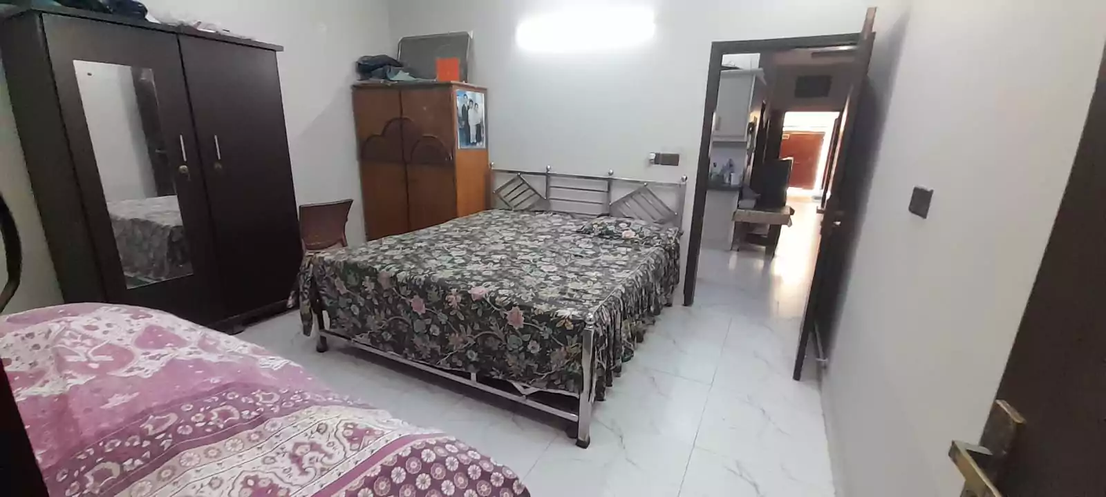 Prime Ground Floor Portion for Sale in North Nazimabad Block C Karachi (12) Bedroom in ground floor portion for sale North Nazimabad Block C with wooden wardrobe mirror double bed metal frame tiled flo