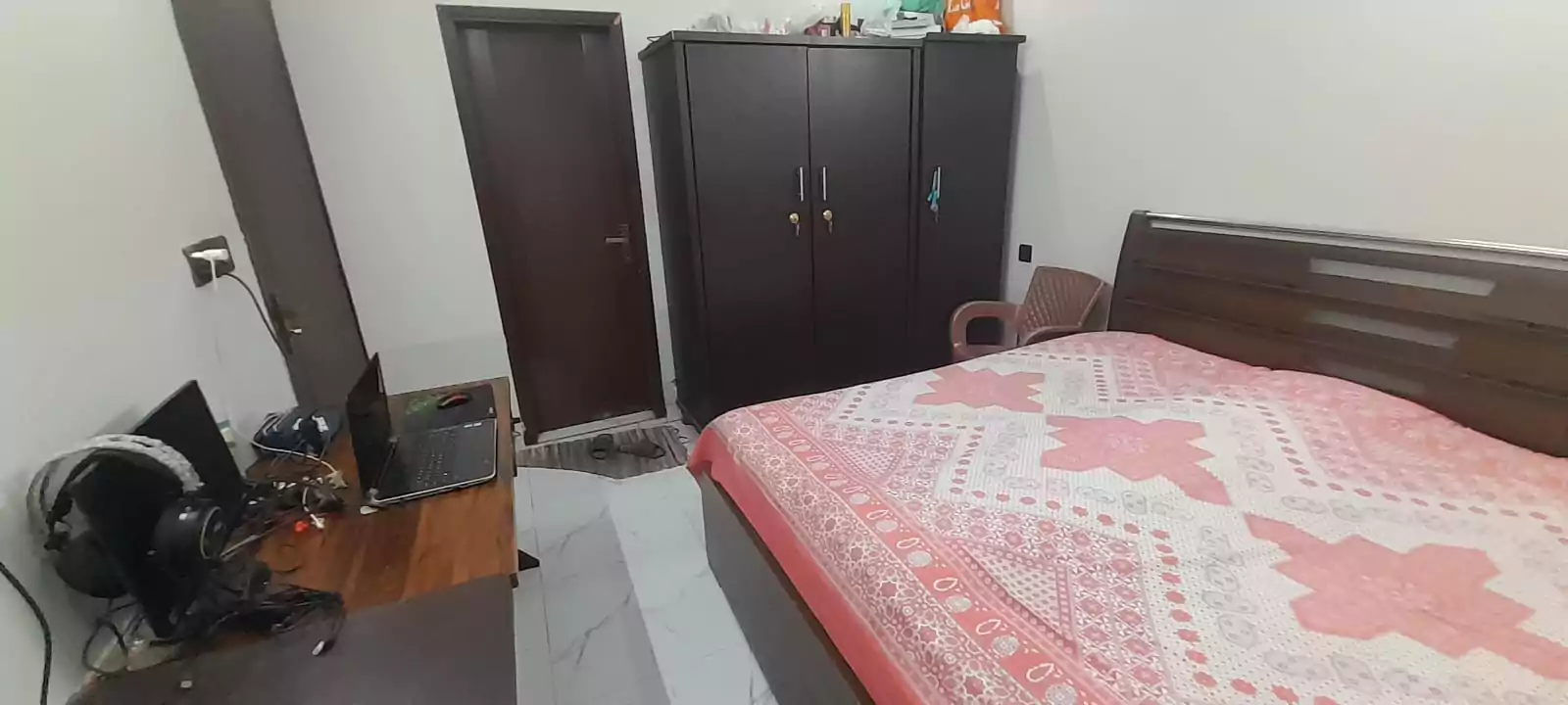 Prime Ground Floor Portion for Sale in North Nazimabad Block C Karachi (13) Bedroom in ground floor portion for sale North Nazimabad Block C with wooden double bed pink floral sheets wardrobe study des