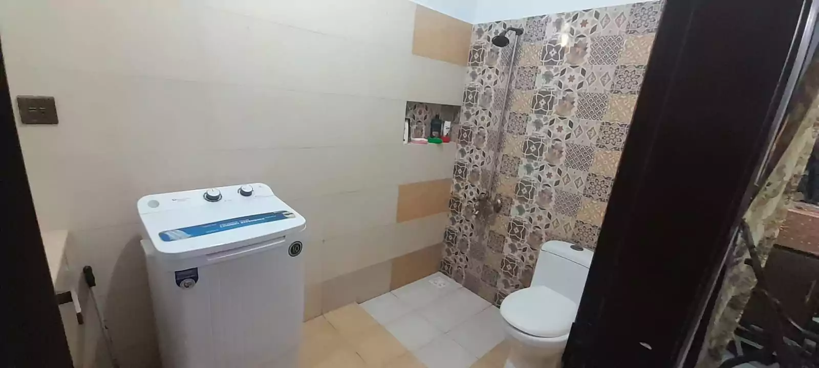 Prime Ground Floor Portion for Sale in North Nazimabad Block C Karachi (6) Bathroom in ground floor portion for sale North Nazimabad Block C with white washing machine toilet and patterned tile shower