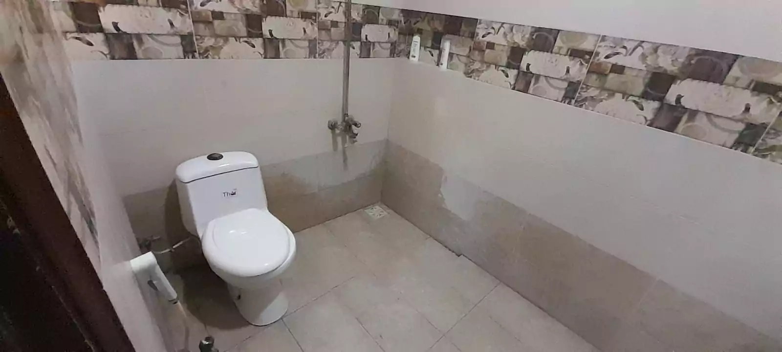 Prime Ground Floor Portion for Sale in North Nazimabad Block C Karachi (7) Bathroom with white toilet, beige tiled floor, brick-patterned upper walls in ground floor portion, North Nazimabad Block C