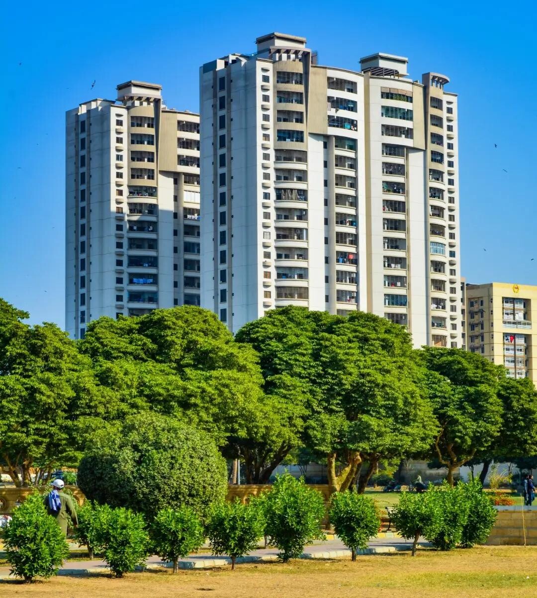 luxurious-3-bedroom-apartment-zamzam-towers-civil-lines.webp Zamzam Towers high-rise apartments in Civil Lines Karachi with white facades balconies and lush green trees landscaping