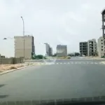 Wide Avenue With Zebra Crossing And Under-Construction Multi-Story Buildings In Al Murtaza Commercial Area, Dha