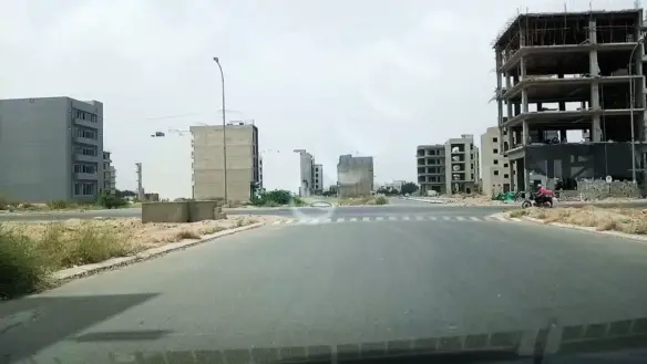 Wide Avenue With Zebra Crossing And Under-Construction Multi-Story Buildings In Al Murtaza Commercial Area, Dha
