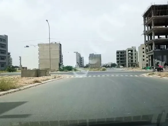 Wide Avenue With Zebra Crossing And Under-Construction Multi-Story Buildings In Al Murtaza Commercial Area, Dha