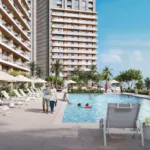 Maxx Capitals Emaar Park Edge Waterfront Apartment Pool Area With High-Rise Balconies, Loungers, And Palm Landscaping