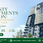 Modern High-Rise Dynasty Apartments In Clifton With Sleek White And Black Facade And Spacious Balconies Under A Clear Blue Sk