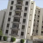 Bath Island Pride Luxury Building In Clifton, Multi-Story White Facade With Balconies, Large Windows, Trees And Hedges