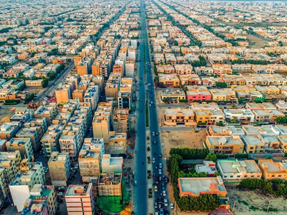 Aerial View Of Dense Residential Buildings And Houses Along A Wide Straight Boulevard In Ameer Khusro, Dha Phase 6 Karachi
