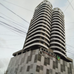 Modern Twin-Tower Apartment Building In Country 8 Clifton With Curved White Facades, Balconies, And Dark Accents